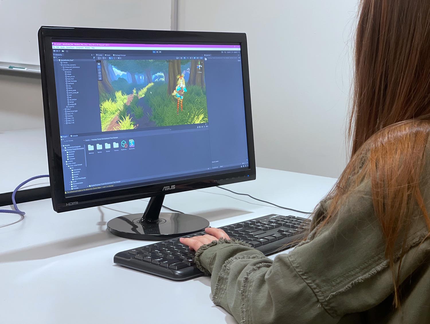 Young girl coding a 3D game