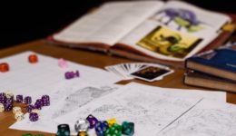Game map, book and dice on a table