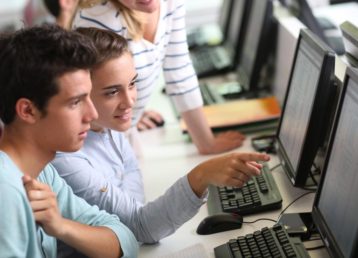 Three students working together at a computer